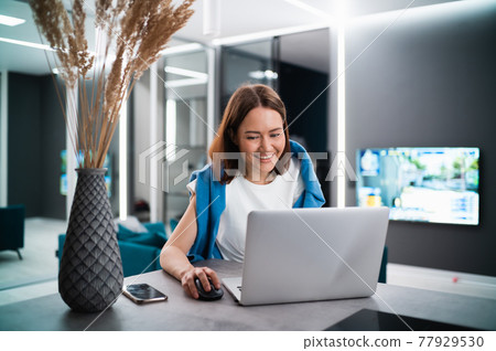 Portrait of gamer girl playing online game on a laptop from home Portrait of gamer girl playing online game on a laptop from home 77929530