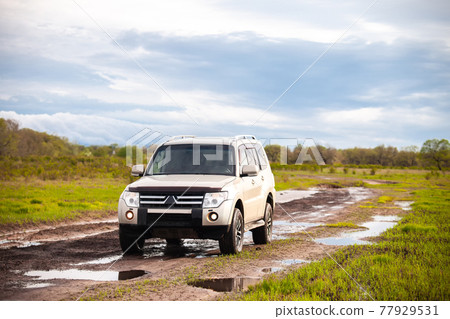 Mitsubishi Pajero (Montero) at dirt road after rain 77929531