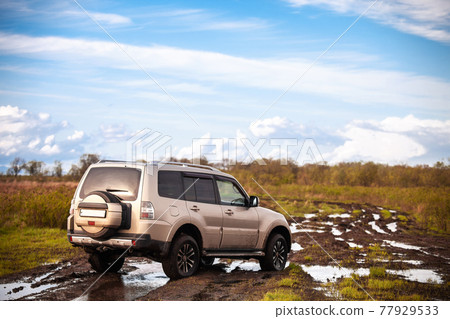 Mitsubishi Pajero/Montero at dirt road after rain 77929533