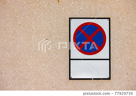 Stop and parking are prohibited sign on sand wall 77929739