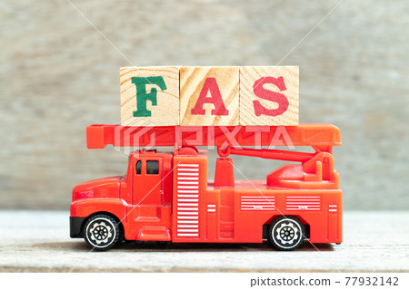 Fire ladder truck hold letter block in word FAS (Abbreviation of Fetal alcohol syndrome, Free alongside or Financial accounting standards) on wood background Fire ladder truck hold letter block in word FAS (Abbreviation of Fetal alcohol syndrome, Free alongside or Financial accounting standards) on wood background 77932142