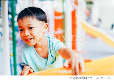 Little boy playing with playset 77932240