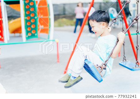 Little boy playing with playset 77932241