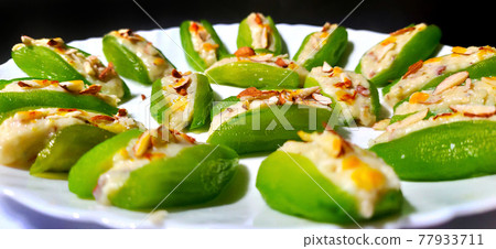 Pointed gourd sweets isolated in black background. Pointed gourd sweets isolated in black background. 77933711