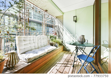 Balcony with cushions and table 77933750