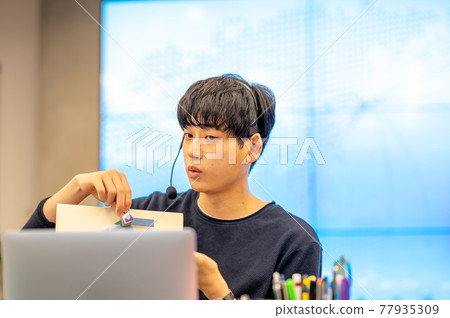 A scene of teleworking in a casual office with a large screen A scene of teleworking in a casual office with a large screen 77935309