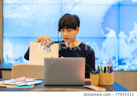 A scene of teleworking in a casual office with a large screen A scene of teleworking in a casual office with a large screen 77935313