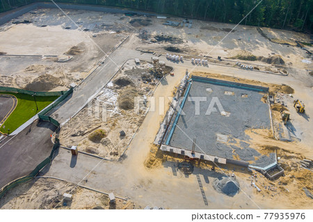 Preparation for a wall construction site, form blocks being filled with concrete Preparation for a wall construction site, form blocks being filled with concrete 77935976