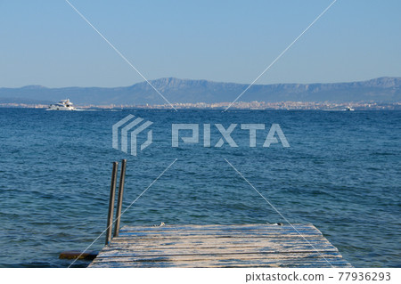 Wooden jetty over sea 77936293