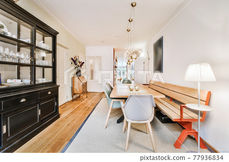 Cozy dining area with wooden bench Cozy dining area with wooden bench 77936834