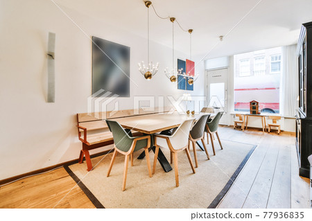 Cozy dining area with wooden bench Cozy dining area with wooden bench 77936835