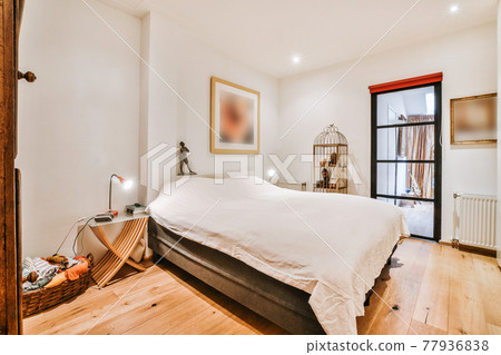 Cozy light bedroom with wooden floor Cozy light bedroom with wooden floor 77936838