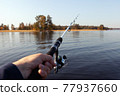 fishing rod in hand on the background of the autumn island 77937660