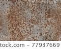 rusty stains on the surface of a metal sheet. 77937669