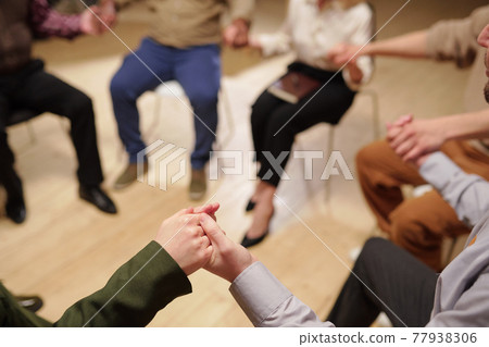 Group of patients of psychological course holding by hands 77938306