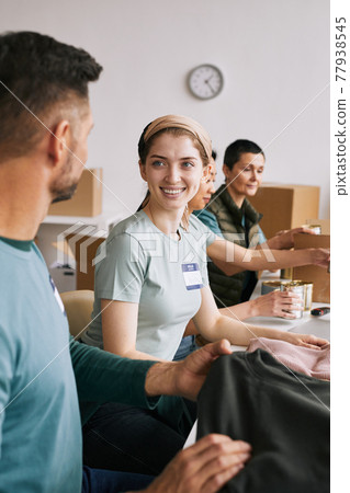 Smiling Volunteers in Donations Center Smiling Volunteers in Donations Center 77938545
