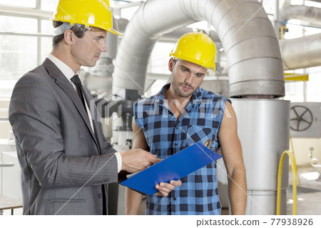 Industrial working men at factory working away Industrial working men at factory working away 77938926