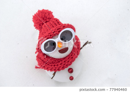 Snowman in sunglasses 77940460