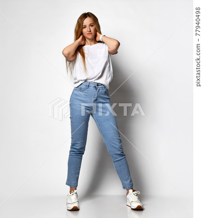 Stock photo of young, fit and sexy woman in jeans 77940498