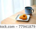 Sugar donuts and mug on a plate 77941879