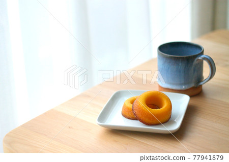 Sugar donuts and mug on a plate Sugar donuts and mug on a plate 77941879