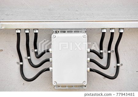 External electrical junction box with corrugated cable channels and wires. Professional wire 77943481
