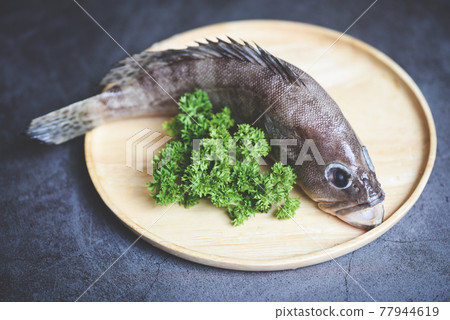 Grouper fish on wooden plate, Fresh raw seafood fish for cooked food 77944619