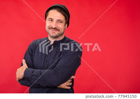Smiling man in casual wear on red background, insurance, lending, investments 77945150