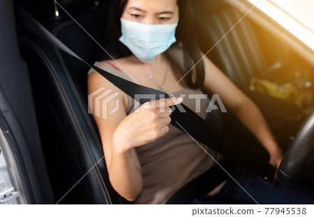 Woman driver fastens seat belt before driving a car,Safety concept for vehicles 77945538