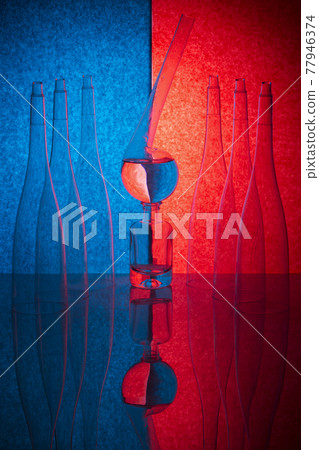 Still life with glass objects on a colored background 77946374