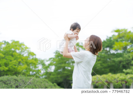 Hug parent and child baby green background 77946782