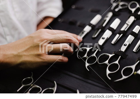 Hair salon concept a collection of scissors made of stainless in different sizes kept in specific leather case Hair salon concept a collection of scissors made of stainless in different sizes kept in specific leather case 77947499