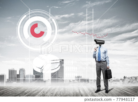 Camera headed man standing on wooden floor against modern cityscape Camera headed man standing on wooden floor against modern cityscape 77948117