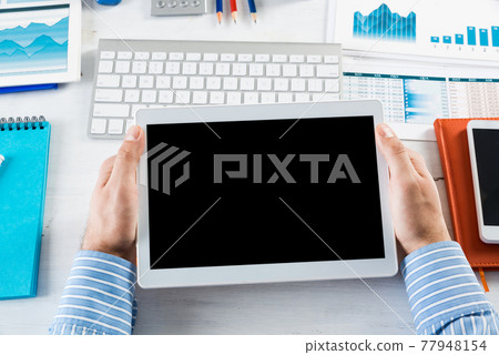 businessman with a tablet, works in the office businessman with a tablet, works in the office 77948154