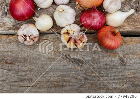 Fresh garlic and onion on a rustic wooden table. Top view, copy space 77948296