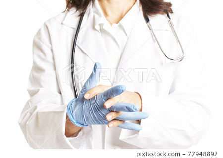 Female doctor adjusting blue latex gloves. Health concept Female doctor adjusting blue latex gloves. Health concept 77948892