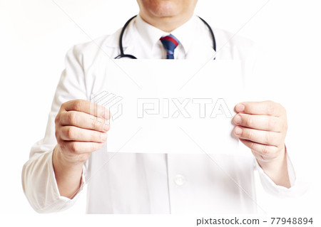 Doctor with a stethoscope holding a blank cardboard with both hands Doctor with a stethoscope holding a blank cardboard with both hands 77948894