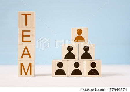 Wooden toy cubes with painted men in hierarchical order and inscription team. 77949874