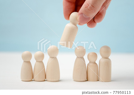 Hand puts or removes wooden figure in the center of figures lined up. 77950113