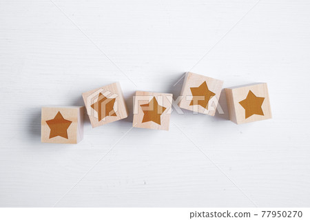 Five stars on wooden blocks showing the best rating. Best score. Flat lay. 77950270