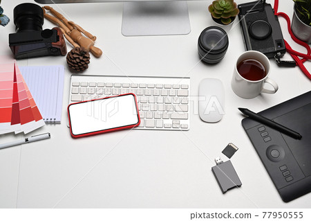 Mobile phone, graphic tablet and camera accessories on photographer workplace. Mobile phone, graphic tablet and camera accessories on photographer workplace. 77950555