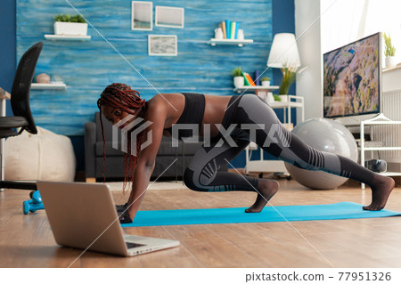 Black fit athletic woman training for muscle strenght 77951326