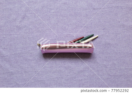 Pencil case with pens on purple fabric background. flat lay, top view, copy space Pencil case with pens on purple fabric background. flat lay, top view, copy space 77952292