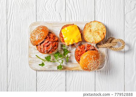 Sloppy Joe sandwiches on a cutting board, top view 77952888