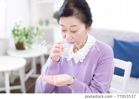 senior woman taking medicine senior woman taking medicine 77953537