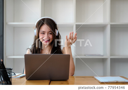 Side view shot smiling asian woman freelancer wearing headset, communicating with client via video computer call. Millennial pleasant professional female tutor giving online language class Side view shot smiling asian woman freelancer wearing headset, communicating with client via video computer call. Millennial pleasant professional female tutor giving online language class 77954346