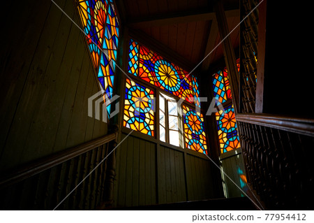 Authentic balcony of an old residential building with a stained glass window made of multicolored mosaics 77954412