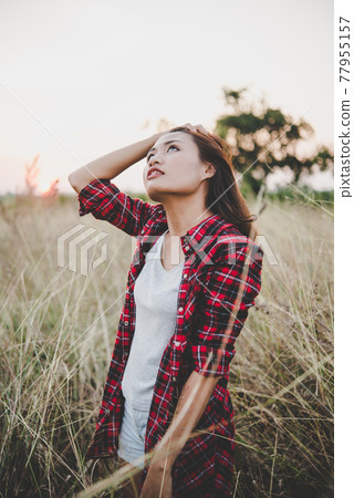 Close up of lonely woman alone in a field. Vintage filter style. Close up of lonely woman alone in a field. Vintage filter style. 77955157