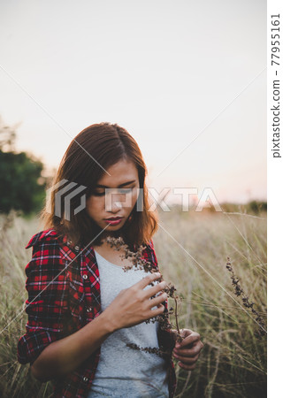Close up of beautiful sad young girl in a field. Vintage filter style. Close up of beautiful sad young girl in a field. Vintage filter style. 77955161