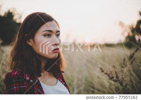 Close up of beautiful sad young girl in a field. Vintage filter style. Close up of beautiful sad young girl in a field. Vintage filter style. 77955162